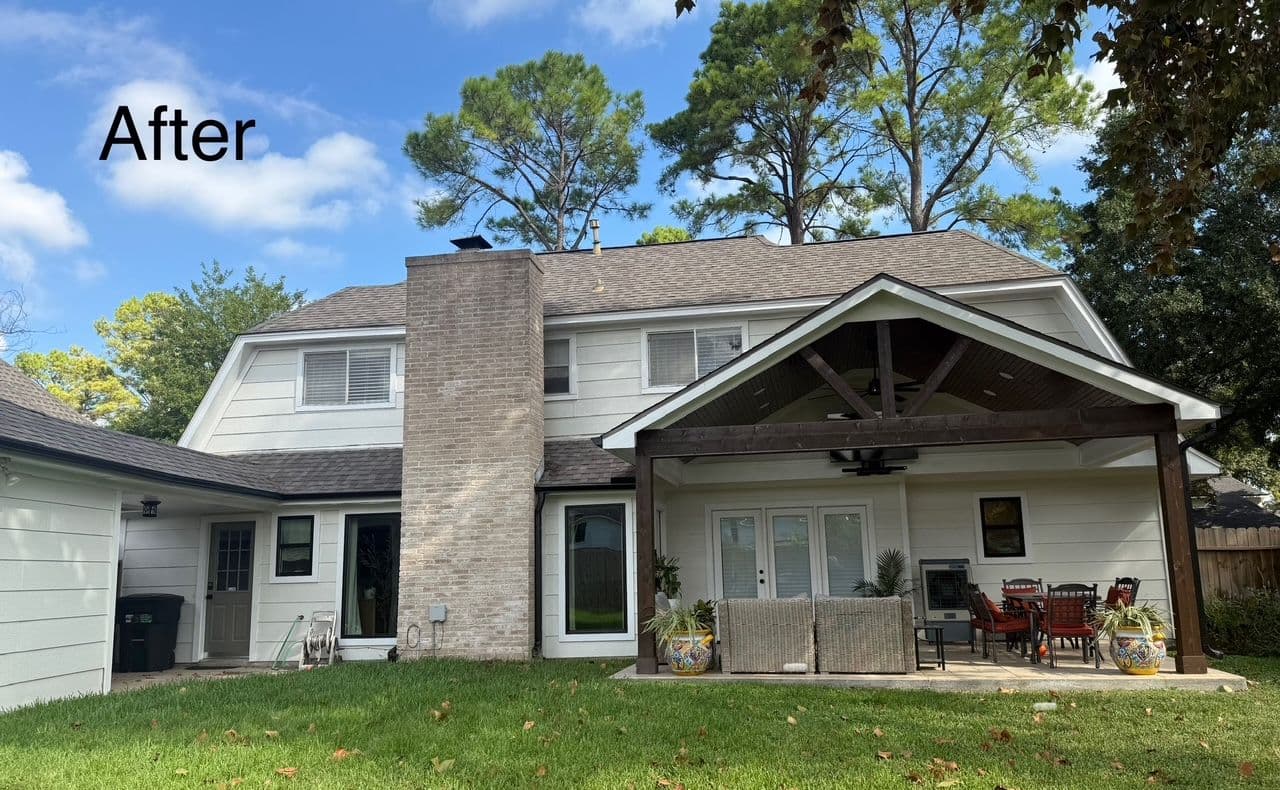 Modern home exterior with well-maintained backyard and stylish outdoor seating area.